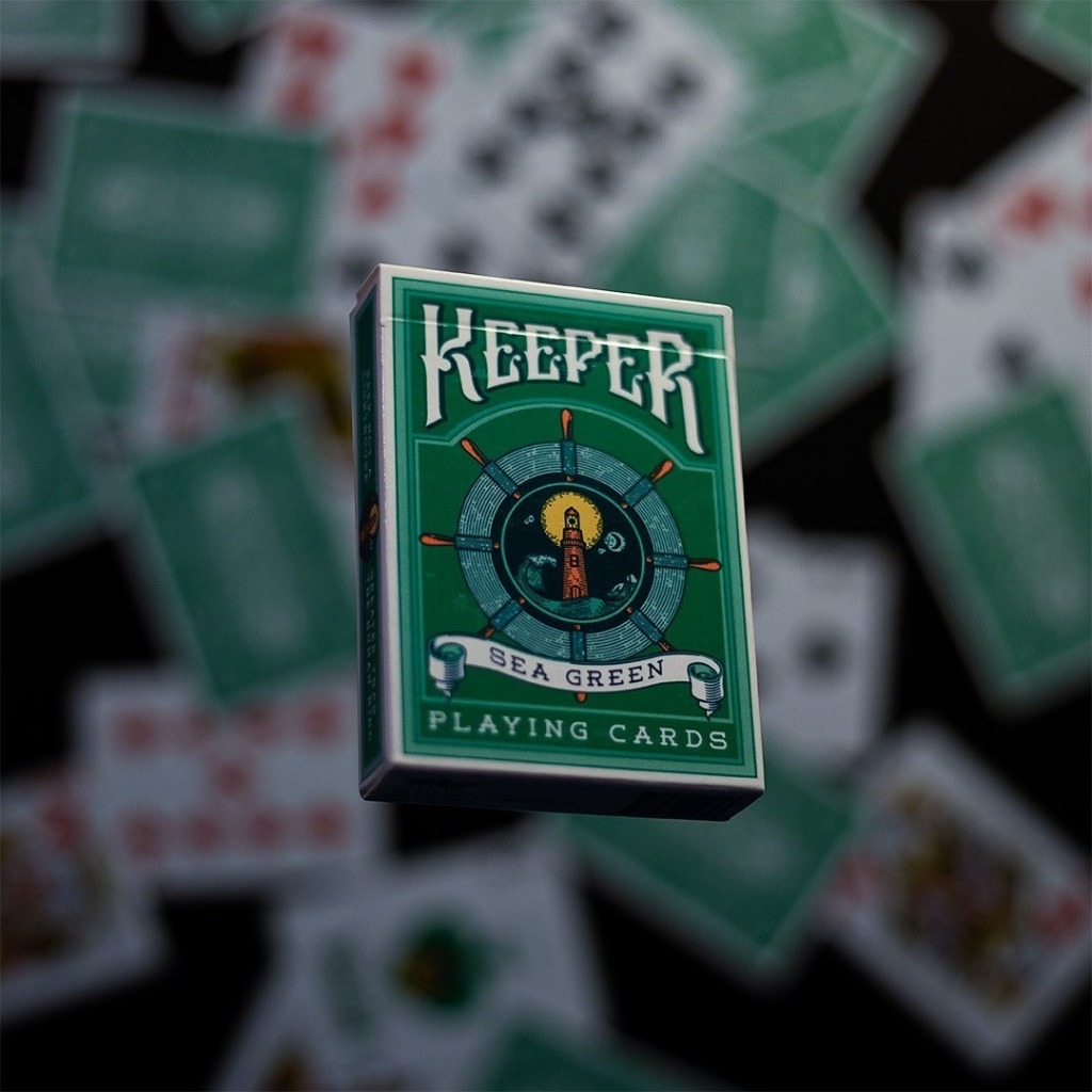 Keeper sea green playing cards levitating above scattered deck